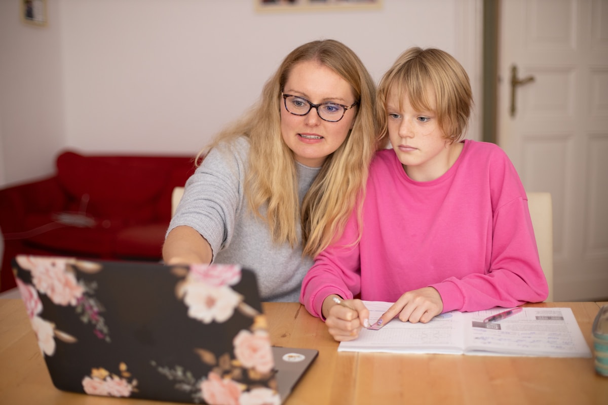 Parent and child working together at a laptop